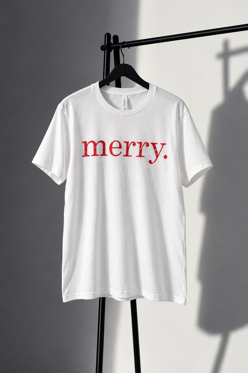 White Bella Canvas tee with distressed red lowercase merry screen print