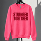 Neon pink Stronger Together sweatshirt with straight horizontal lettering on black studio rack